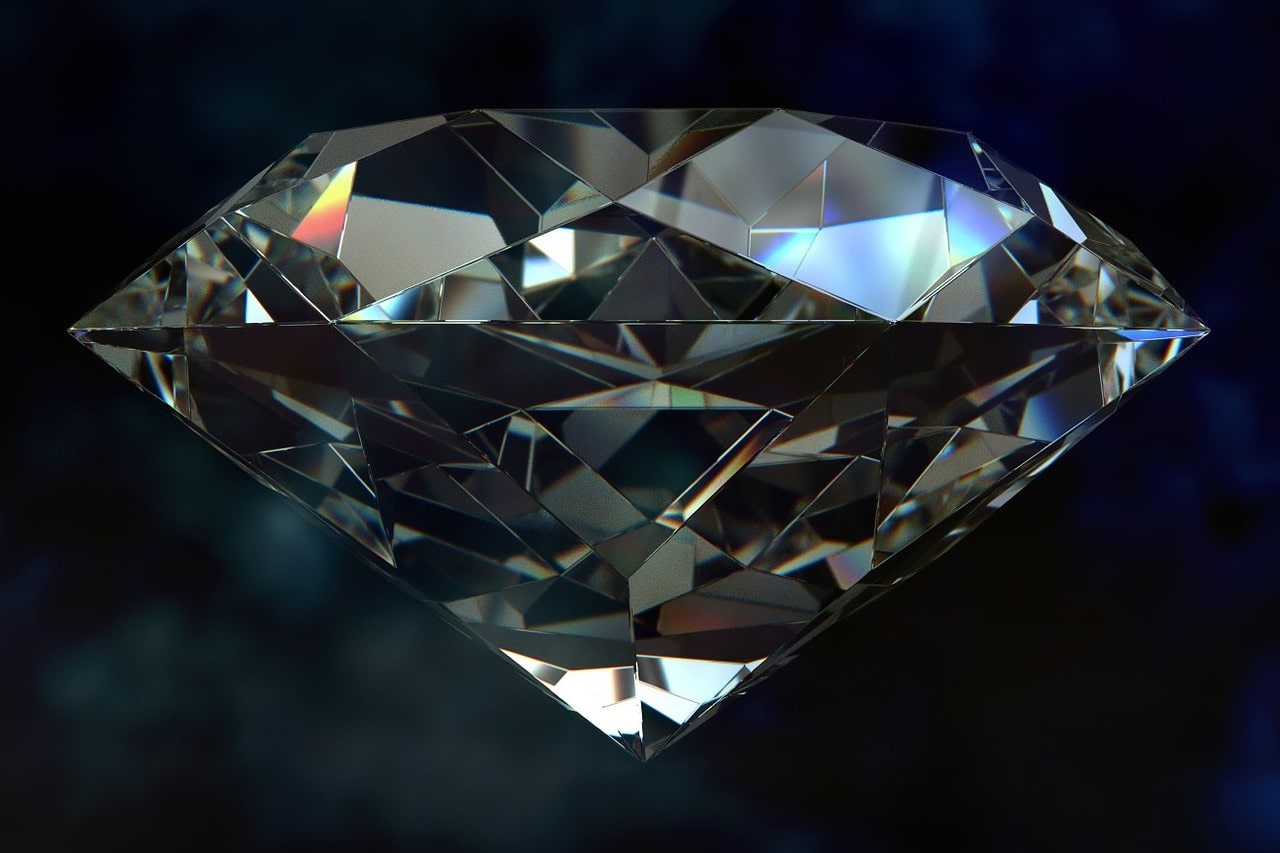 Close up image of a round cut diamond against a dark background Close up image of a round cut diamond against a dark background