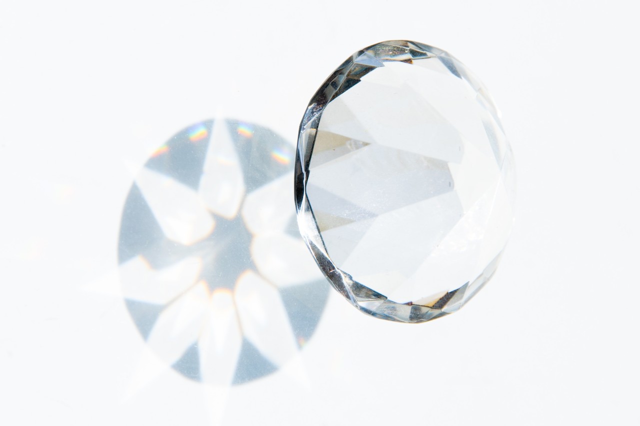 Close up image of a round cut diamond against a white background Close up image of a round cut diamond against a white background